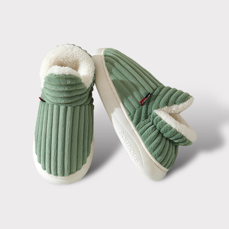 Close-up lifestyle view of green therapeutic slippers showing comfort and quality construction.