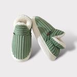 Close-up lifestyle view of green therapeutic slippers showing comfort and quality construction.