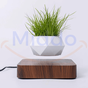 FloatPot levitating plant pot in dark brown ceramic finish.