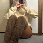 Stylish brown FluffSoks cozy socks worn as a fashion accessory with winter outfit.