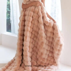 Fluffy winter blanket draped to show the thick, luxurious faux fur.