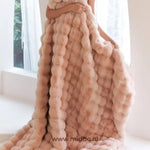 Fluffy winter blanket draped to show the thick, luxurious faux fur.