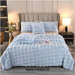 Fluffy winter blanket in light blue faux fur, extra thick and cozy.