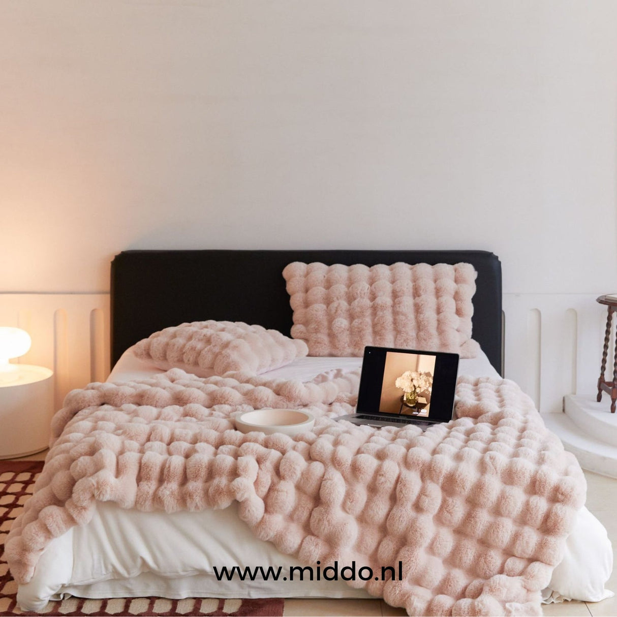 Fluffy winter blanket in pink faux fur, perfect for soft home decor.
