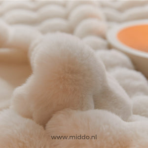 Close-up detail of fluffy faux fur blanket's plush, soft material.