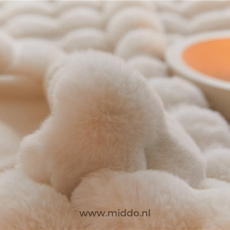 Close-up detail of fluffy faux fur blanket's plush, soft material.
