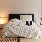 Fluffy winter blanket in white faux fur, creating elegant home warmth.