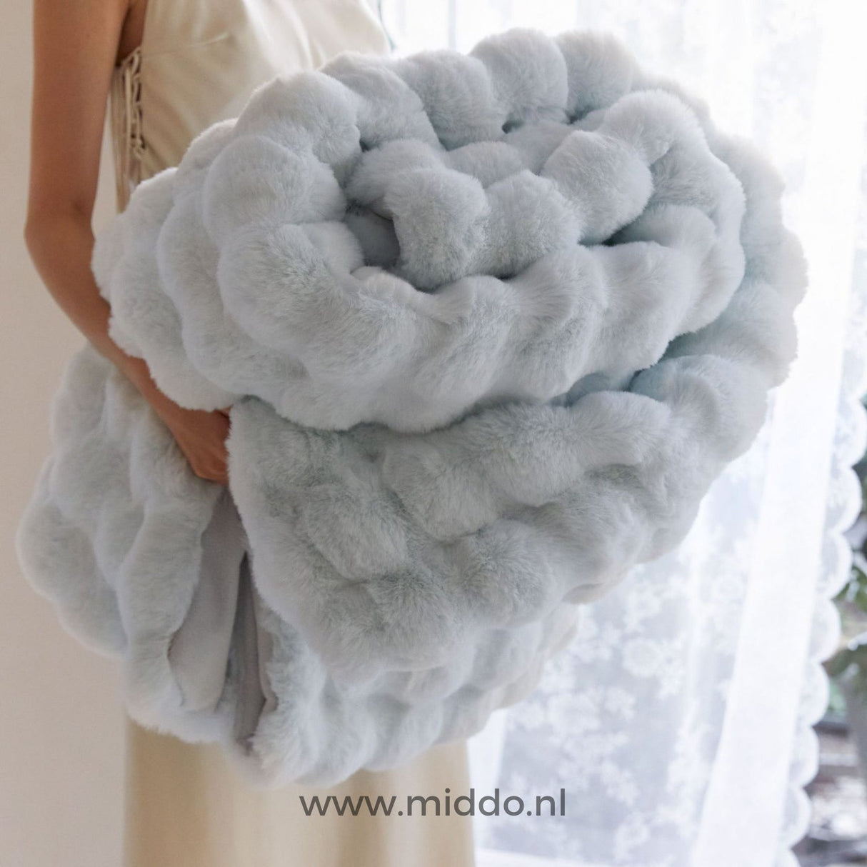 Fluffy blanket being worn and used, showing real-world comfort application.