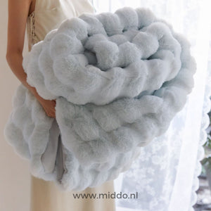 Fluffy blanket being worn and used, showing real-world comfort application.