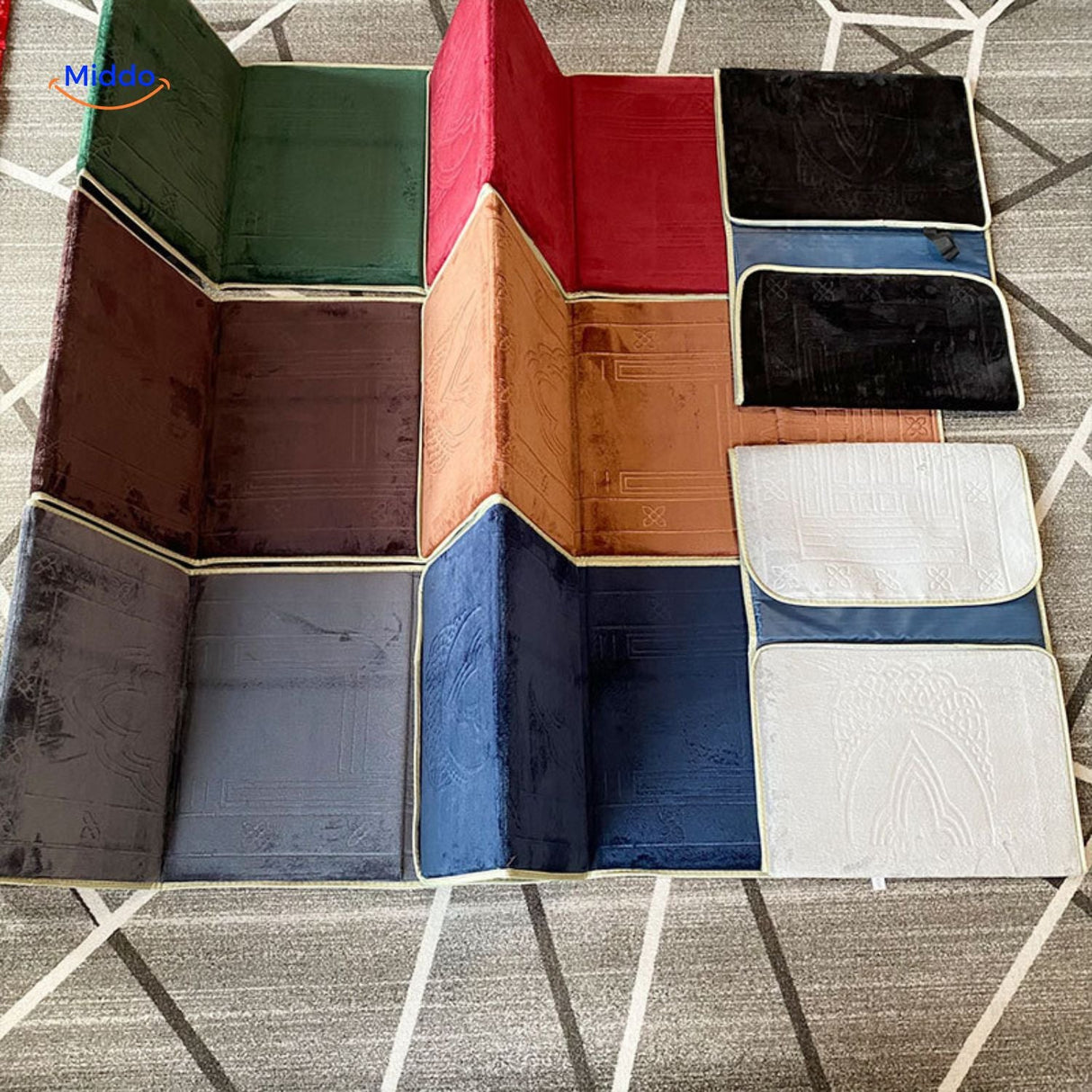 Foldable travel prayer mats laid flat showing all available colors side by side.