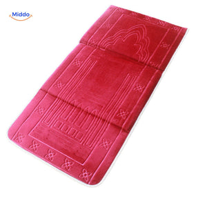 Foldable padded travel prayer mat in rich red color, folded for portability.