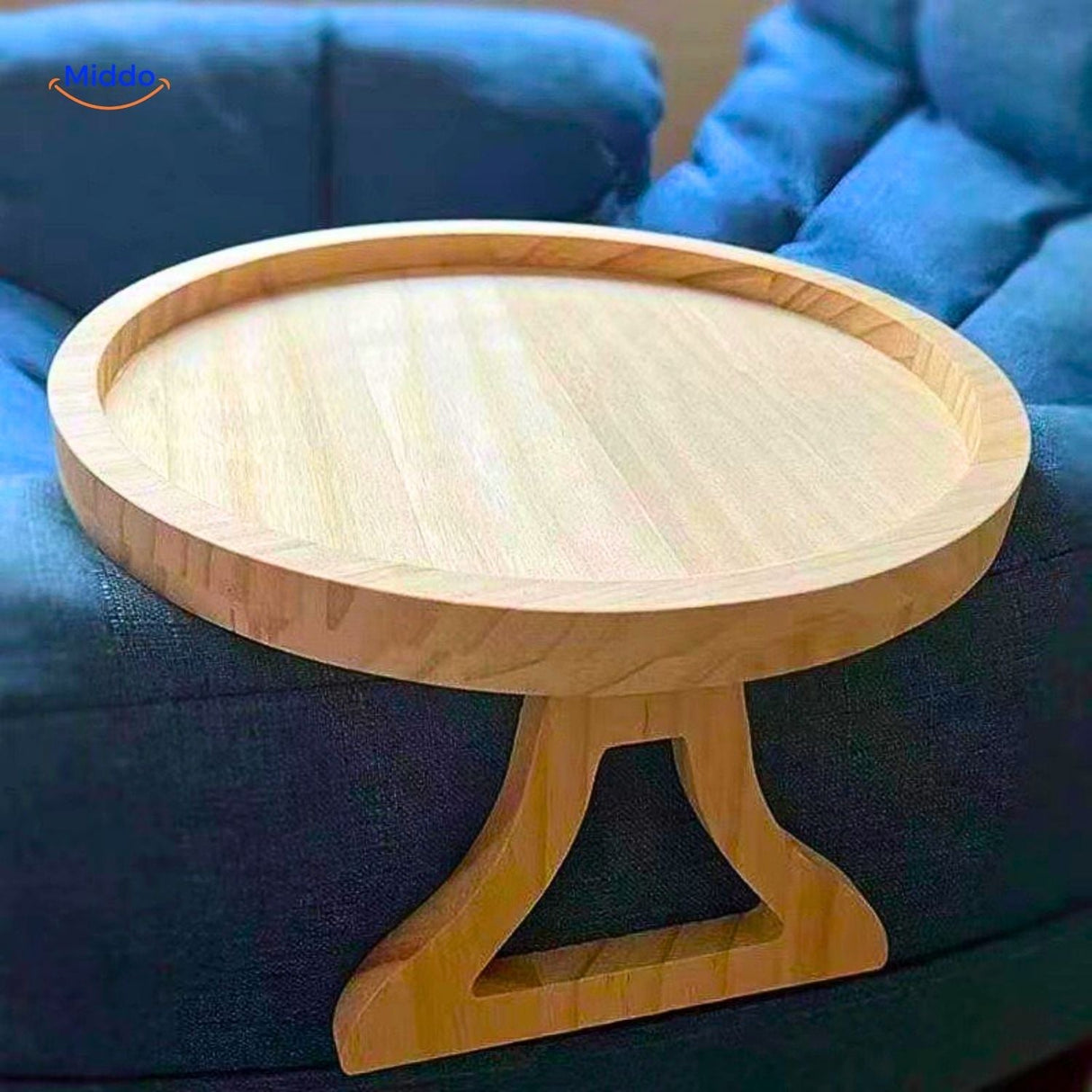 ComfyGrip sofa table installed on blue upholstered armrest with bamboo tray surface.