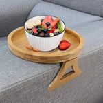 ComfyGrip sofa tray holding breakfast bowl and fresh fruit salad on armrest.