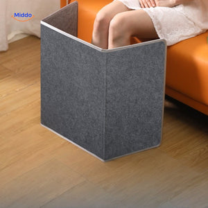 Portable heating pad positioned on couch for feet warming comfort.