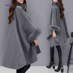 Back view of Furina wool cape coat revealing structured design and faux-fur collar trim.