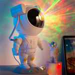 Galaxy projector displaying colorful light show with starry nebula effects in dark room.