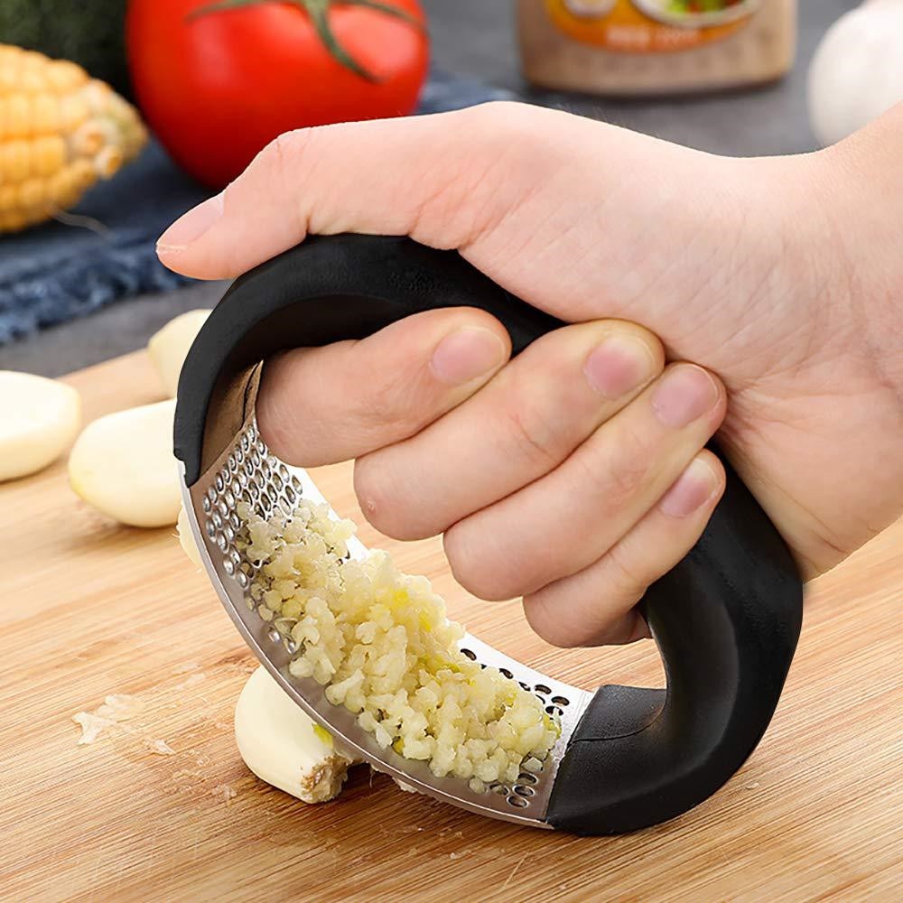 HandyPress stainless steel garlic press with minced garlic freshly pressed out.