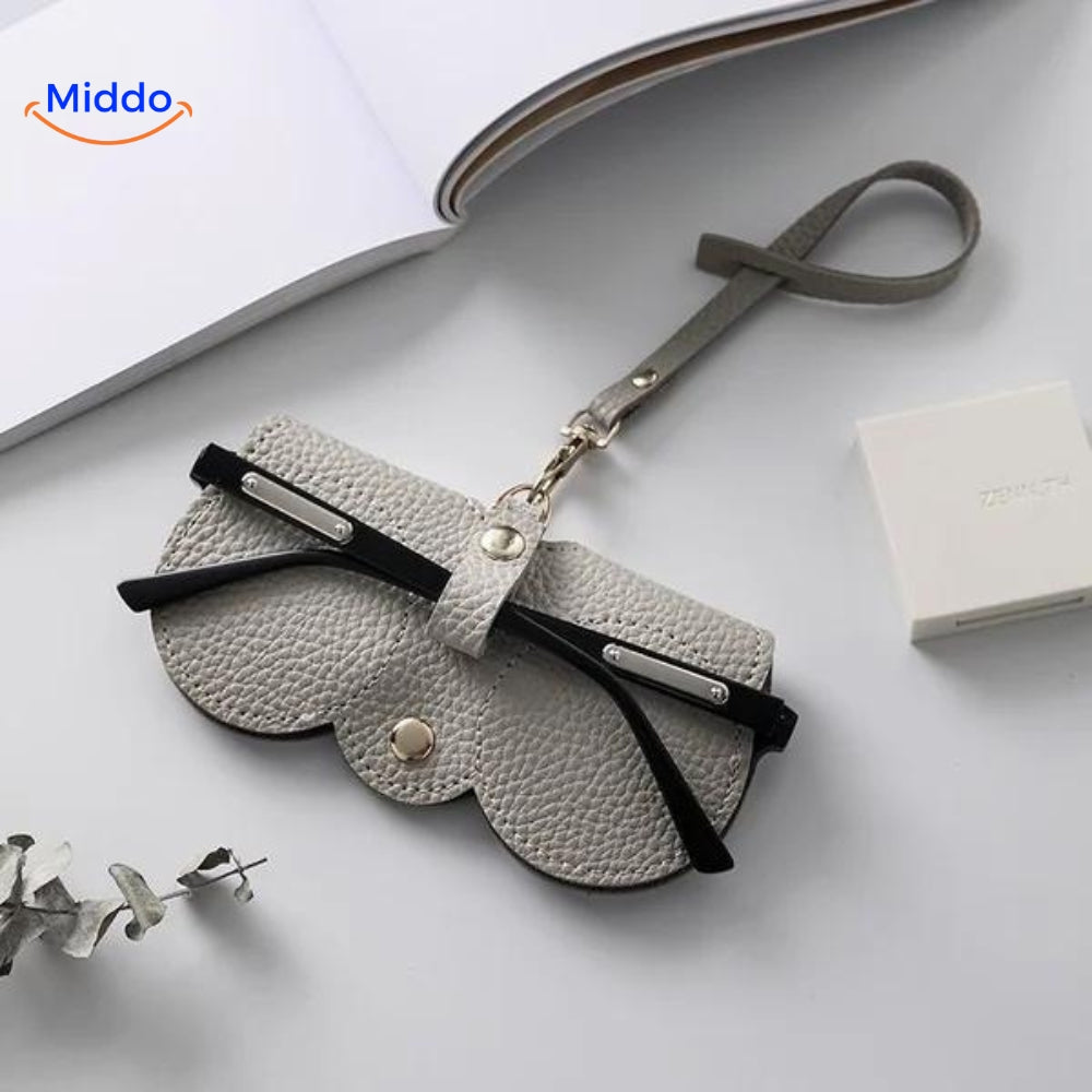 Compact leather glasses case in grey tone for understated eyewear storage.