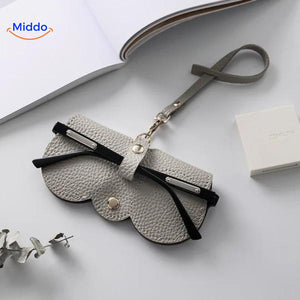 Compact leather glasses case in grey tone for understated eyewear storage.