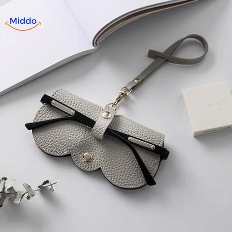 Compact leather glasses case in grey tone for understated eyewear storage.