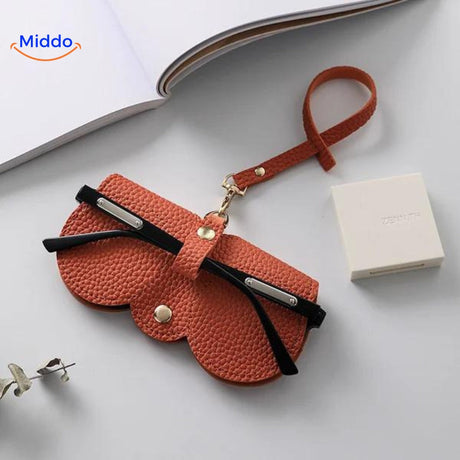 Slim leather glasses case in vibrant orange for stylish eyewear protection.