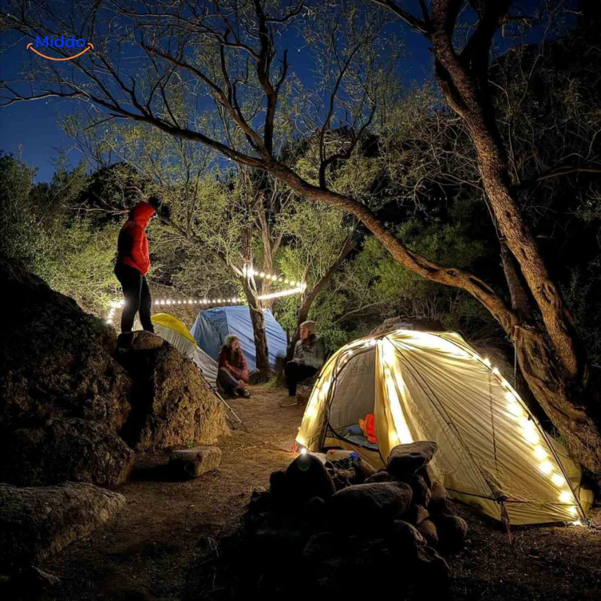 GlowMate creating atmospheric lighting around tent in nature.