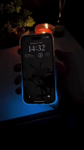 GlowSand phone case glowing in dark with LED-inspired luminous liquid effect.