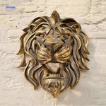 Golden lion head resin sculpture wall mounted in a modern contemporary interior space.
