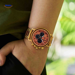 Golden wood chronograph watch worn on wrist displaying luxury design.