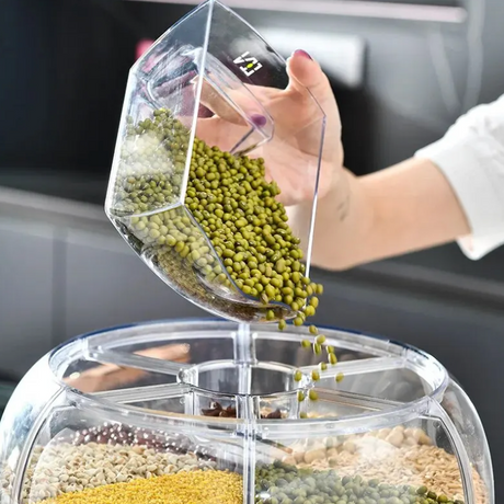 Filling rotating grain dispenser with green beans showing easy refill operation.