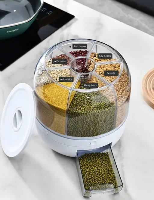 Top-down view of rotating grain dispenser filled with beans, seeds, and rice.