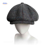 Gray herringbone wool newsboy cap with comfortable all-season fit.