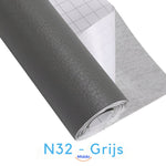 Gray self-adhesive leather patch for neutral gray furniture restoration.