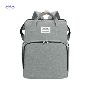 Gray trendy diaper backpack with foldable bassinet and practical organization.
