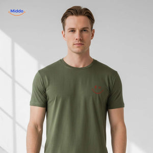 Close-up of smiley print on green cotton t-shirt.