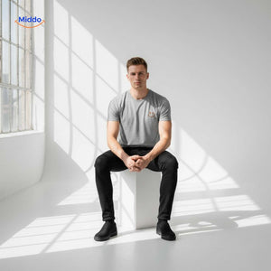 Grey smiley print t-shirt in minimalist seated studio pose.
