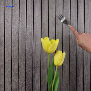 Macro detail shot of grey wood-grain 3D wall panel surface showing realistic texture.