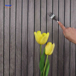 Macro detail shot of grey wood-grain 3D wall panel surface showing realistic texture.