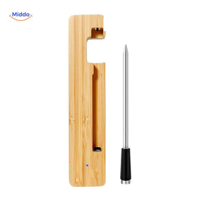Meat thermometer resting in elegant bamboo charging dock holder.