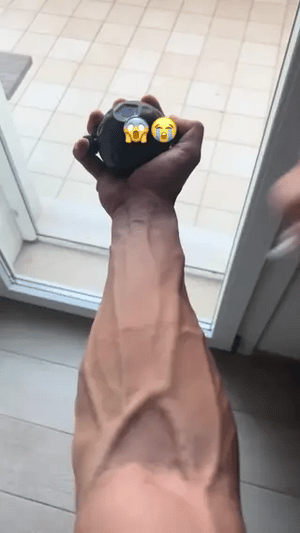 Hand grip strengthening exercise using GripFlex trainer with resistance massage ball.