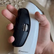 Hand grip trainer showing real-time digital strength measurement in action.