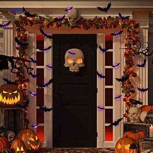 3D LED bat wall light with Halloween decoration in outdoor setting.