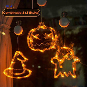Halloween LED window lamps showing pumpkin, witch hat, and ghost shapes hung as window decoration.