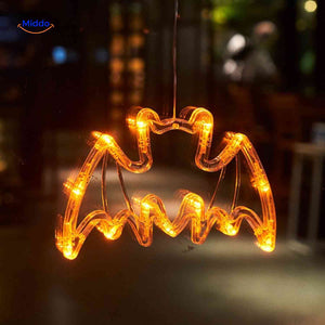 Halloween LED window lamp with glowing bat silhouette, adding spooky orange light to any window.