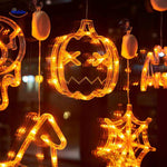 Halloween LED window lamps grouping pumpkin, witch hat, and spiderweb shapes in warm orange light.