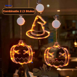 Halloween LED window lamp set featuring pumpkin and witch hat shapes glowing in warm orange light.