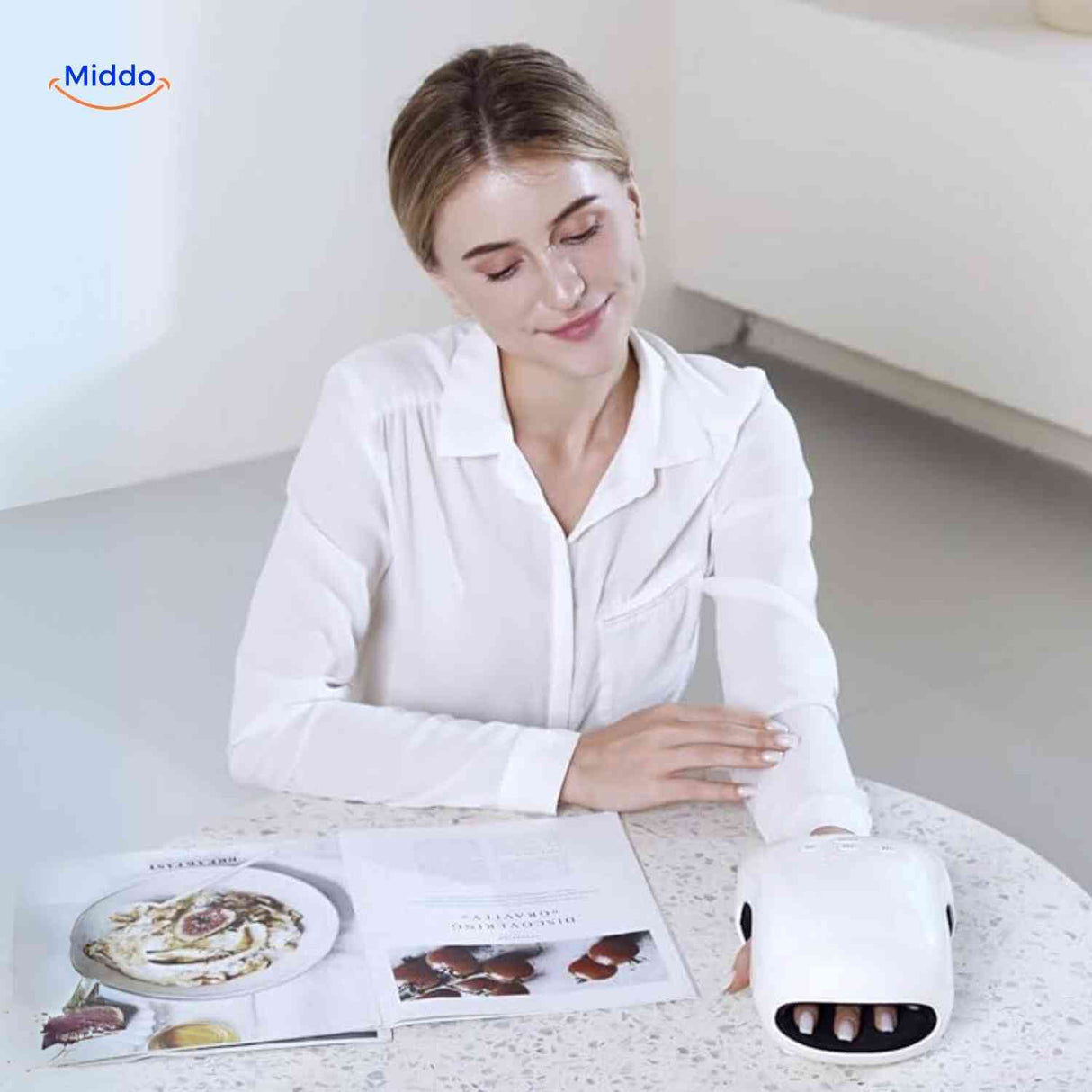 Heated hand massager in use while reading, providing relaxing air compression therapy