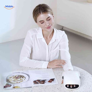 Heated hand massager in use while reading, providing relaxing air compression therapy