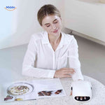 Heated hand massager in use while reading, providing relaxing air compression therapy