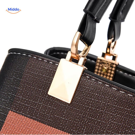 Handle detail and golden velcro closure mechanism of spacious tote.